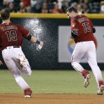 Arizona Diamondbacks' Phil Gosselin (15) is splashed by teammate Mitch Haniger after hitting a winning RBI-single against the San Diego Padres during the ninth inning of a baseball game, Sunday, Oct. 2, 2016, in Phoenix. (AP Photo/Ralph Freso)
