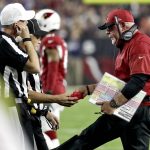 Arizona Cardinals head coach Bruce Arians hands the referees the red flag during the first half of a football game against the Seattle Seahawks, Sunday, Oct. 23, 2016, in Glendale, Ariz. (AP Photo/Rick Scuteri)