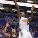Phoenix Suns' Archie Goodwin (20) goes in for a reverse layup against San Antonio Spurs' Bryn Forbes (11) during the second half of an NBA preseason basketball game Monday, Oct. 3, 2016, in Phoenix. The Suns won 91-86. (AP Photo/Ross D. Franklin)