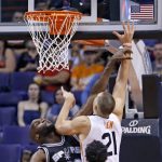 Phoenix Suns' Alex Len (21) gets off a shot as San Antonio Spurs' Joel Anthony (30) defends and Spurs' Dejounte Murray, front, looks on during the first half of an NBA preseason basketball game, Monday, Oct. 3, 2016, in Phoenix. (AP Photo/Ross D. Franklin)