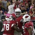 Arizona Cardinals running back David Johnson, center, celebrates his touchdown run with guard Earl Watford (78) and tight end Darren Fells (85) during the first half of an NFL football game against the New York Jets, Monday, Oct. 17, 2016, in Glendale, Ariz. (AP Photo/Rick Scuteri)