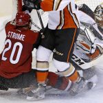 Arizona Coyotes' Dylan Strome (20) collides with Anaheim Ducks goalie Jonathan Bernier, right, during overtime of a preseason NHL hockey game Saturday, Oct. 1, 2016, in Glendale, Ariz.  The Coyotes defeated the Ducks 3-2 in overtime. (AP Photo/Ross D. Franklin)