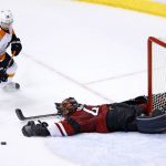 Arizona Coyotes' Mike Smith, right, makes a diving save on a shot by Philadelphia Flyers' Matt Read (24) during overtime of an NHL hockey game Saturday, Oct. 15, 2016, in Glendale, Ariz. The Coyotes defeated the Flyers 4-3. (AP Photo/Ross D. Franklin)