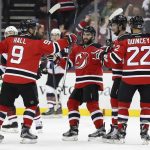 New Jersey Devils left wing Taylor Hall (9) celebrates with teammates after scoring a goal against the Arizona Coyotes during the first period of an NHL hockey game, Tuesday, Oct. 25, 2016, in Newark, N.J. (AP Photo/Julie Jacobson)