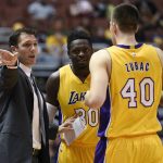 Los Angeles Lakers coach Luke Walton, left, talks with forward Julius Randle, center, and center Ivica Zubac during the first half of the team's NBA preseason basketball game against the Phoenix Suns in Anaheim, Calif., Friday, Oct. 21, 2016. (AP Photo/Kelvin Kuo)