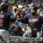 Cleveland Indians' Carlos Santana is congratulated by Francisco Lindor after hitting a home run off Chicago Cubs starting pitcher John Lackey during the second inning of Game 4 of the Major League Baseball World Series Saturday, Oct. 29, 2016, in Chicago. (AP Photo/David J. Phillip)