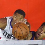 Los Angeles Clippers forward Wesley Johnson, left, and Phoenix Suns forward Marquese Chriss reach for a rebound during the first half of an NBA basketball game, Monday, Oct. 31, 2016, in Los Angeles. (AP Photo/Mark J. Terrill)