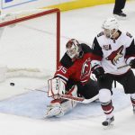 Arizona Coyotes center Martin Hanzal (11) watches as the puck, shot by Arizona Coyotes defenseman Oliver Ekman-Larsson (23), slips past New Jersey Devils goalie Cory Schneider (35) during the third period of an NHL hockey game, Tuesday, Oct. 25, 2016, in Newark, N.J. The Devils won 5-3. (AP Photo/Julie Jacobson)