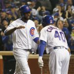 Chicago Cubs' Dexter Fowler, left, celebrates with Willson Contreras after scoring a run during the first inning of Game 4 of the Major League Baseball World Series against the Cleveland Indians, Saturday, Oct. 29, 2016, in Chicago. (AP Photo/Nam Y. Huh)