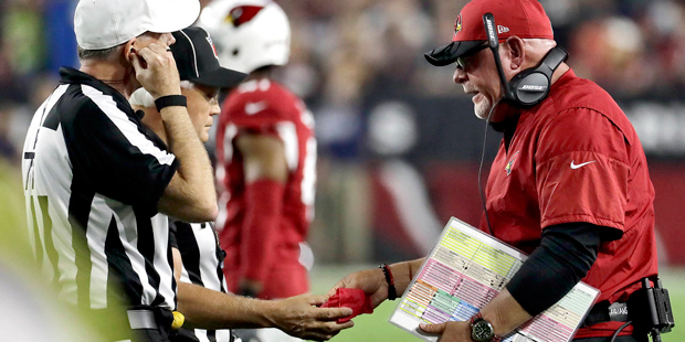 Arizona Cardinals head coach Bruce Arians hands the referees the red flag during the first half of ...