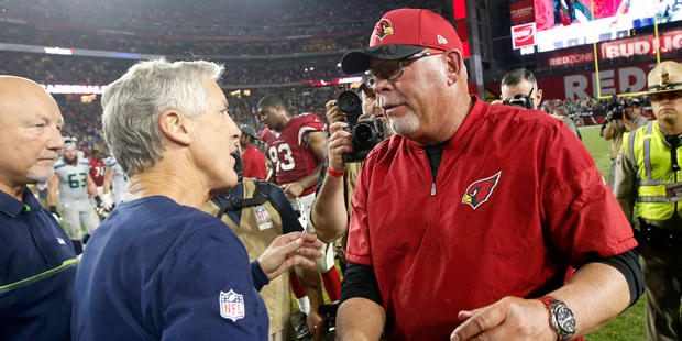 Seattle Seahawks head coach Pete Carroll, left, greets Arizona Cardinals head coach Bruce Arians af...
