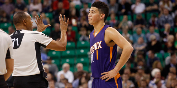 Phoenix Suns' Devin Booker (1) reacts to a foul being called against his team during the first half...
