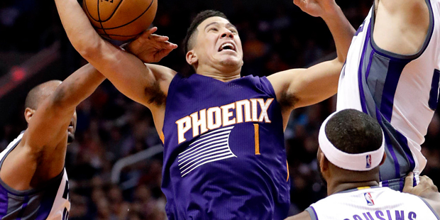 Phoenix Suns guard Devin Booker (1) loses the ball Sacramento Kings center Kosta Koufos, right, and...