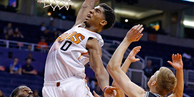 Phoenix Suns' Marquese Chriss (0) leaps in vain to grab a rebound as he jumps between San Antonio S...