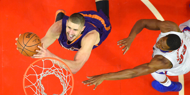 Phoenix Suns center Alex Len, left, of Ukraine, shoots as Los Angeles Clippers forward Wesley Johns...