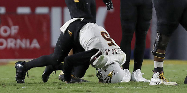 Arizona State quarterback Manny Wilkins (5) stays on the ground after being sacked during the first...