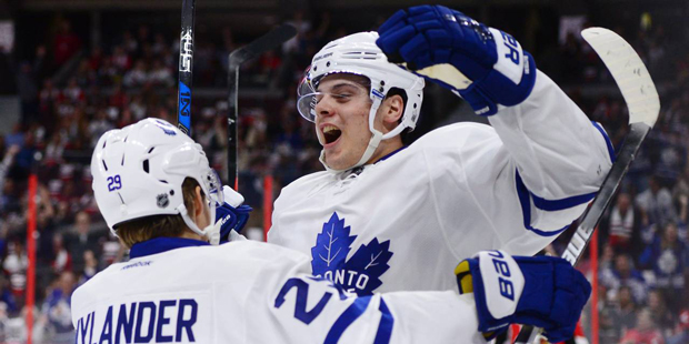 Toronto Maple Leafs center Auston Matthews, right, celebrates a first period goal against the Ottaw...