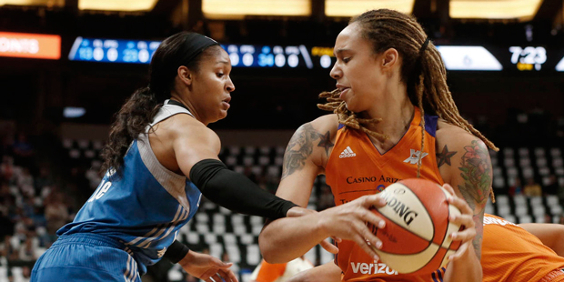 Phoenix Mercury's Brittney Griner, right, keeps the ball away as Minnesota Lynx's Maya Moore defend...