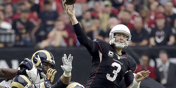 Arizona Cardinals quarterback Carson Palmer (3) throws under pressure from Los Angeles Rams defensi...