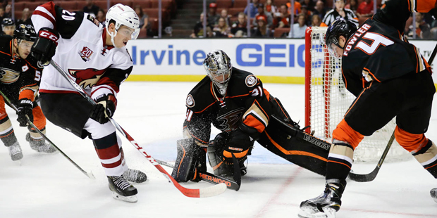 Anaheim Ducks' Cam Fowler, right, moves the puck away from Arizona Coyotes' Dylan Strome, left, in ...