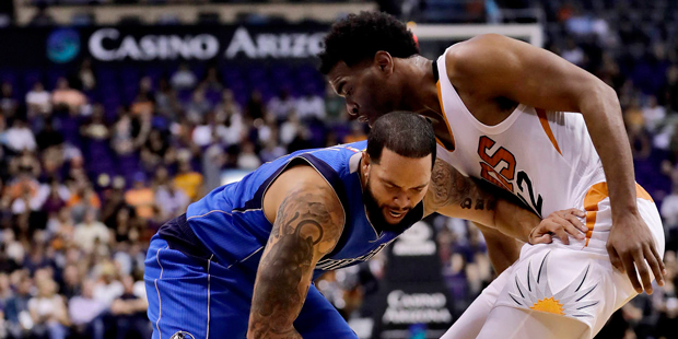 Phoenix Suns' T.J. Warren, left, scores as he gets past San Antonio Spurs' Davis Bertans (42) durin...