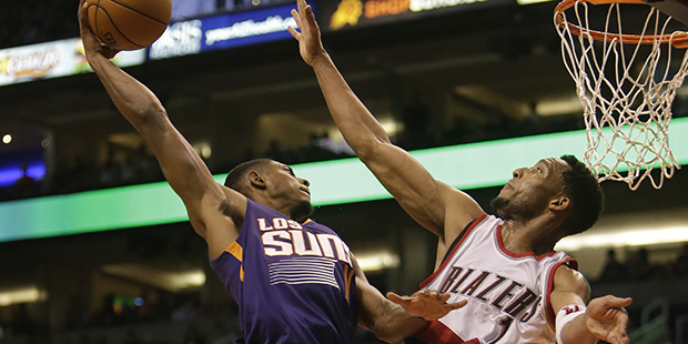Phoenix Suns guard Brandon Knight dunks over Portland Trail Blazers guard Evan Turner (1) in the se...