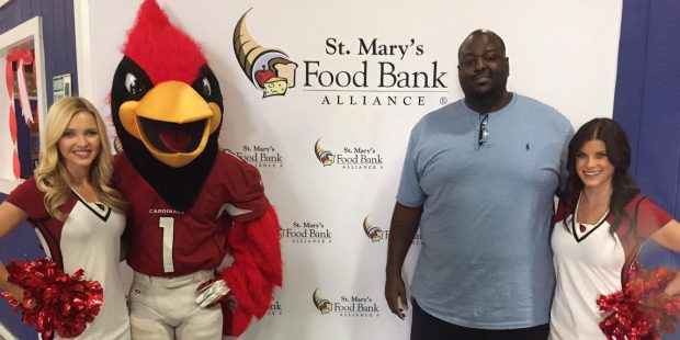 Former Arizona Cardinals guard Jerome Daniels, Big Red and two Cardinals cheerleaders kicked off th...