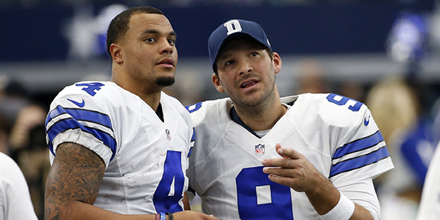 Dallas Cowboys' Dak Prescott (4) and Tony Romo (9) talk on the sideline in the first half of an NFL...