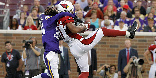 Arizona Cardinals wide receiver Larry Fitzgerald, right, catches a pass in front of Minnesota Vikin...