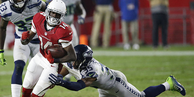 Arizona Cardinals wide receiver J.J. Nelson (14) runs for a first down after the catch as Seattle S...
