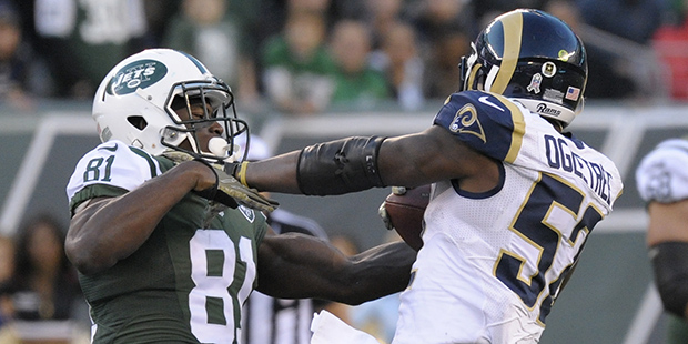 Los Angeles Rams middle linebacker Alec Ogletree (52) comes down with an interception on a pass intended for New York Jets wide receiver Quincy Enunwa (81) during the fourth quarter of an NFL football game, Sunday, Nov. 13, 2016, in East Rutherford, N.J. The Rams won 9-6. (AP Photo/Bill Kostroun)