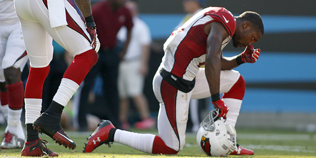 Arizona Cardinals' Patrick Peterson (21) kneels in defeat as the final seconds tick off the clock d...