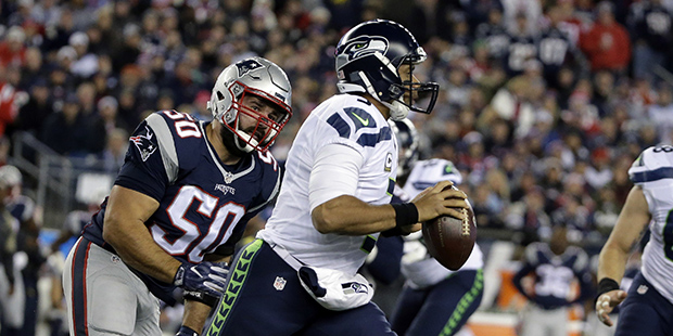 Seattle Seahawks quarterback Russell Wilson (3) scrambles away from New England Patriots defensive end Rob Ninkovich (50) during the first half of an NFL football game, Sunday, Nov. 13, 2016, in Foxborough, Mass. (AP Photo/Steven Senne)