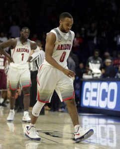 Arizona guard Parker Jackson-Cartwright (0) limps off the court during the first half of the team's NCAA college basketball game against Texas Southern, Wednesday, Nov. 30, 2016, in Tucson, Ariz. (AP Photo/Rick Scuteri)