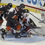 Anaheim Ducks center Rickard Rakell (67) pushes the puck past a crowd, including goalie goalie Justin Peters (40), for his second goal of the night against the Arizona Coyotes, during the third period of an NHL hockey game in Anaheim, Calif., Friday, Nov. 4, 2016. (AP Photo/Reed Saxon)