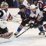 Arizona Coyotes goalie Louis Domingue, left, covers the net as Colorado Avalanche left wing Gabriel Landeskog, center, of Sweden, is slowed down while driving to the crease by Coyotes defenseman Anthony DeAngelo during the first period of an NHL hockey game Tuesday, Nov. 8, 2016, in Denver. (AP Photo/David Zalubowski)