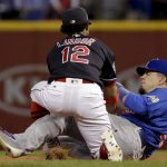 Chicago Cubs' Kyle Schwarber, right, is out at second as Cleveland Indians' Francisco Lindor takes the throw during the third inning of Game 7 of the Major League Baseball World Series Wednesday, Nov. 2, 2016, in Cleveland. Schwarber tried to stretch a single into a double. (AP Photo/Matt Slocum)