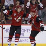 Arizona Coyotes' Christian Dvorak, left, celebrates with teammate Max Domi (16) after Dvorak's first NHL goal, during the first period of the team's hockey game against the Nashville Predators on Thursday, Nov. 3, 2016, in Glendale, Ariz. (AP Photo/Ross D. Franklin)
