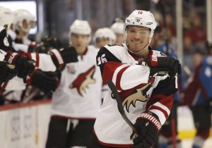Arizona Coyotes left wing Max Domi celebrates after teammate Jordan Martinook score against the Colorado Avalanche during the third period of an NHL hockey game Tuesday, Nov. 8, 2016, in Denver. The Coyotes won 4-2. (AP Photo/David Zalubowski)