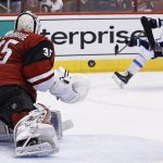 Arizona Coyotes goalie Louis Domingue (35) slides over the make a save against a shot by Winnipeg Jets center Alexander Burmistrov (91) during the first period of an NHL hockey game Thursday, Nov. 10, 2016, in Glendale, Ariz. (AP Photo/Ross D. Franklin)
