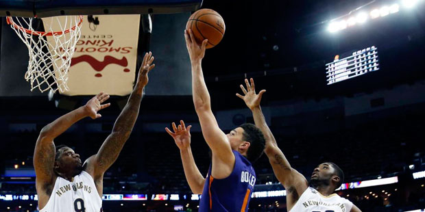 Phoenix Suns guard Devin Booker (1) goes to the basket between New Orleans Pelicans forward Terrenc...