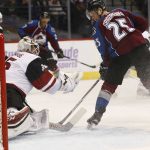 Arizona Coyotes goalie Louis Domingue, left, makes a glove save of a redirected shot off the stick of Colorado Avalanche center Mikhail Grigorenko, of Russia, in the first period of an NHL hockey game Tuesday, Nov. 8, 2016, in Denver. (AP Photo/David Zalubowski)