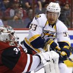 Arizona Coyotes goalie Louis Domingue, left, makes a save on a shot in front of Nashville Predators left wing Colin Wilson (33) during the first period of an NHL hockey game Thursday, Nov. 3, 2016, in Glendale, Ariz. (AP Photo/Ross D. Franklin)