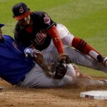 Chicago Cubs' Kyle Schwarber is out at second as Cleveland Indians' Francisco Lindor takes the throw during the third inning of Game 7 of the Major League Baseball World Series Wednesday, Nov. 2, 2016, in Cleveland. Schwarber tried to stretch a single into a double.(AP Photo/Charlie Riedel)