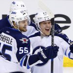 Winnipeg Jets right wing Nikolaj Ehlers (27) celebrates his goal against the Arizona Coyotes with center Mark Scheifele (55) and right wing Patrik Laine (29) during the third period of an NHL hockey game Thursday, Nov. 10, 2016, in Glendale, Ariz. The Jets defeated the Coyotes 3-2. (AP Photo/Ross D. Franklin)