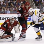 Arizona Coyotes goalie Louis Domingue (35) makes a save on a shot by Nashville Predators left wing Kevin Fiala (56) as Coyotes' Jakob Chychrun (6) defends during the first period of an NHL hockey game Thursday, Nov. 3, 2016, in Glendale, Ariz. (AP Photo/Ross D. Franklin)