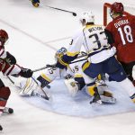 Arizona Coyotes left wing Anthony Duclair (10) scores a goal against Nashville Predators goalie Pekka Rinne (35) as Predators' Colin Wilson (33) and Coyotes' Christian Dvorak (18) battle for position in front of the net during the third period of an NHL hockey game Thursday, Nov. 3, 2016, in Glendale, Ariz. The Coyotes defeated the Predators 3-2 in a shootout. (AP Photo/Ross D. Franklin)