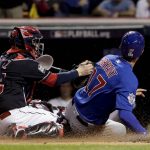 Chicago Cubs' Kris Bryant is safe at home as Cleveland Indians catcher Roberto Perez puts on a late tag during the fourth inning of Game 7 of the Major League Baseball World Series Wednesday, Nov. 2, 2016, in Cleveland. (AP Photo/Matt Slocum)