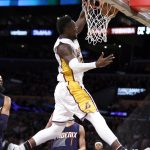 Los Angeles Lakers forward Julius Randle, right, dunks over Phoenix Suns guard Devin Booker (1) during the first half of an NBA basketball game in Los Angeles, Sunday, Nov. 6, 2016. (AP Photo/Alex Gallardo)