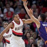 Portland Trail Blazers guard C.J. McCollum, left, knocks the ball away from Phoenix Suns guard Devin Booker during the first half of an NBA basketball game in Portland, Ore., Tuesday, Nov. 8, 2016. (AP Photo/Craig Mitchelldyer)